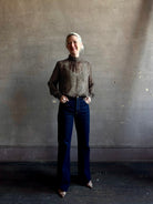 Mature woman wearing Nili Lotan Silk Demie Blouse in Brown/Cream Wild Dots sheer mock neck and keyhole back closure. Made in the USA