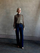 Mature woman wearing Nili Lotan Silk Demie Blouse in Brown/Cream Wild Dots sheer mock neck and keyhole back closure. Made in the USA