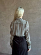 Mature woman wearing Nili Lotan Gaia Slim Silk Shirt in Dark Brown/Cream Stripe button front long sleeve blouse Made in the USA