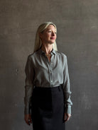 Mature woman wearing Nili Lotan Gaia Slim Silk Shirt in Dark Brown/Cream Stripe classic collar, cuffed sleeves Made in the USA