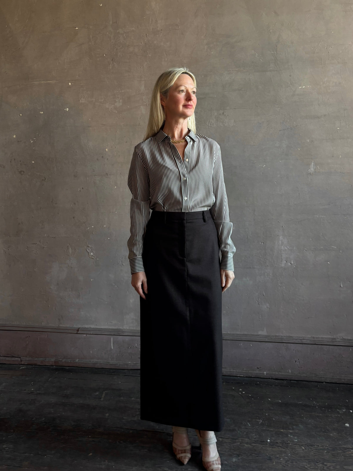 Mature woman wearing Nili Lotan Gaia Slim Silk Shirt in Dark Brown/Cream Stripe tailored long sleeve bouse Made in the USA