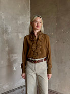 Mature woman wearing Nili Lotan's Lily Long sleeve Blouse Cognac silk delicate front ruffle Warm romantic American-made
