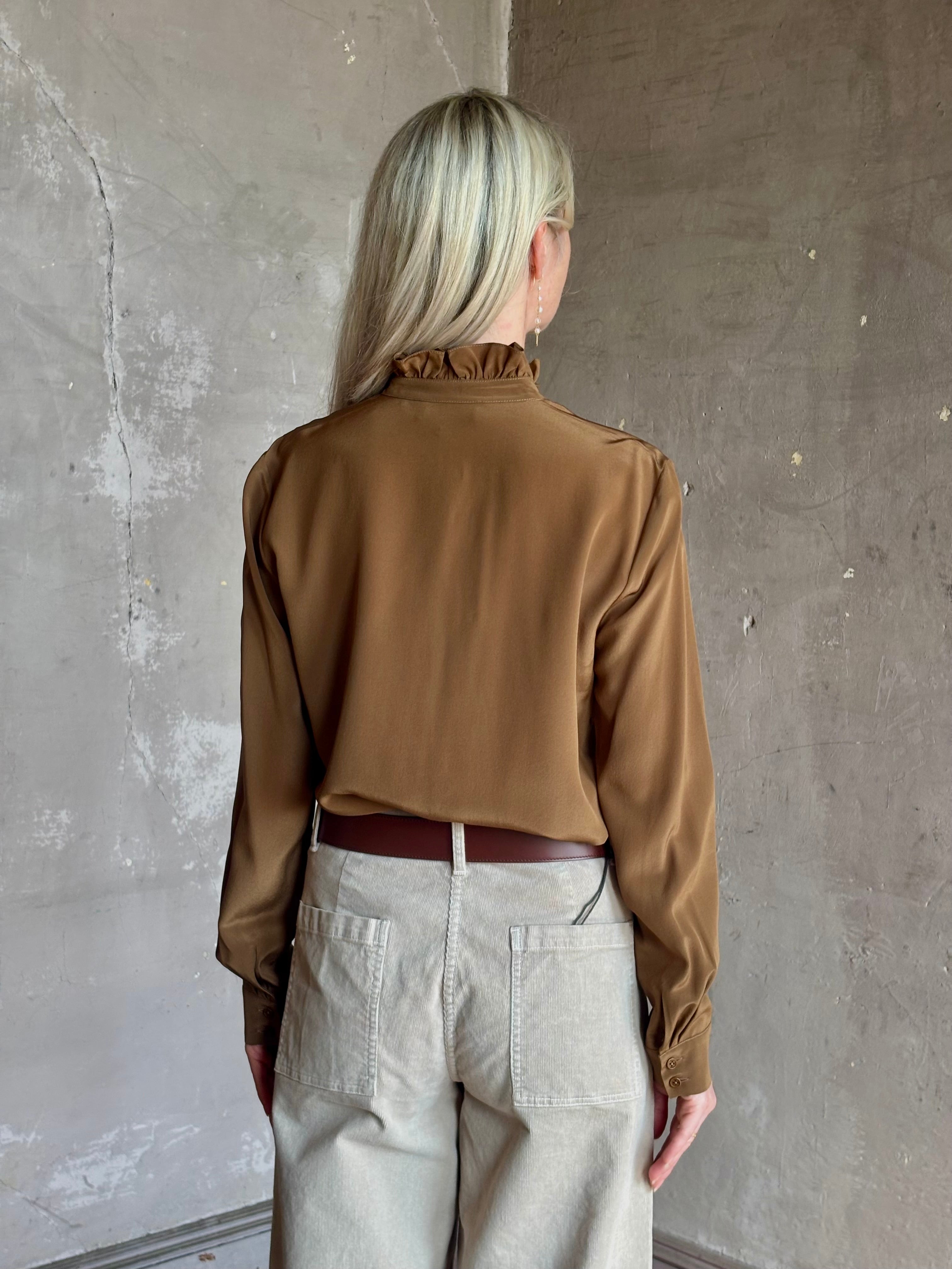 Mature woman wearing Nili Lotan's Lily Long sleeve Blouse Cognac silk delicate front ruffle Warm romantic American-made
