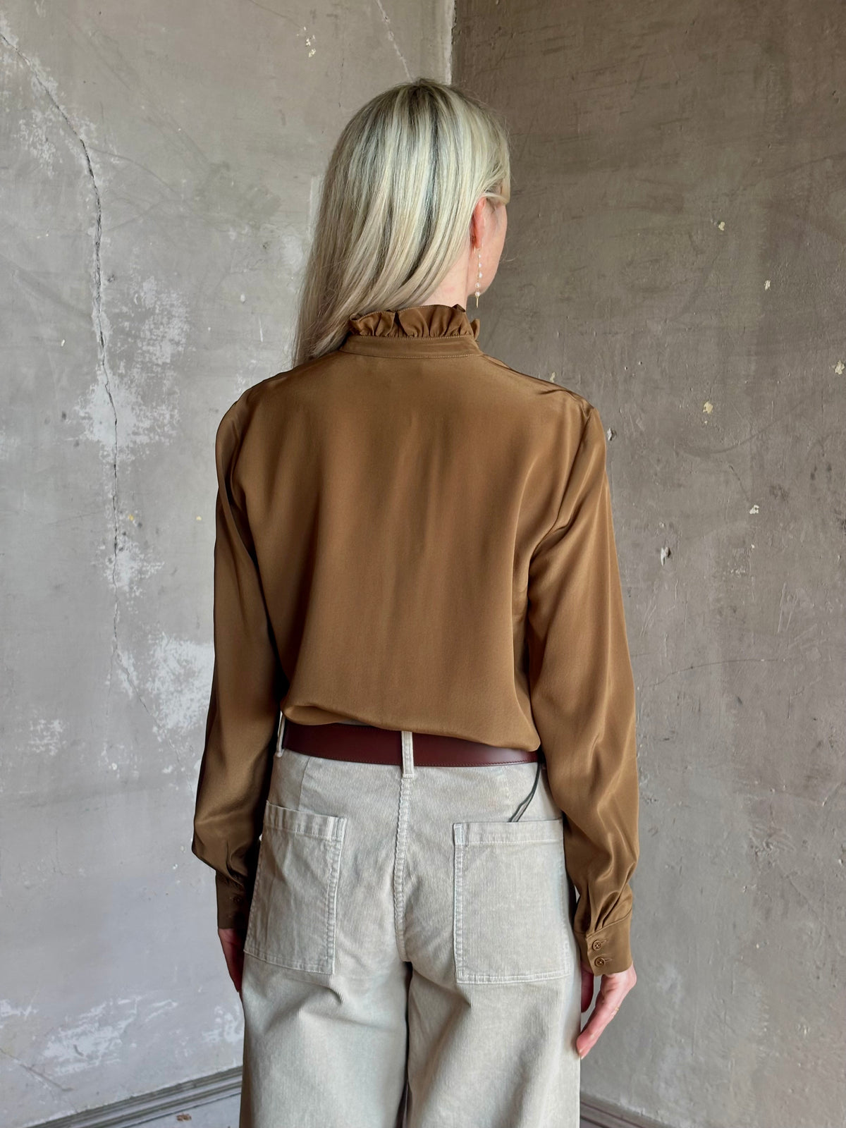 Mature woman wearing Nili Lotan's Lily Long sleeve Blouse Cognac silk delicate front ruffle Warm romantic American-made