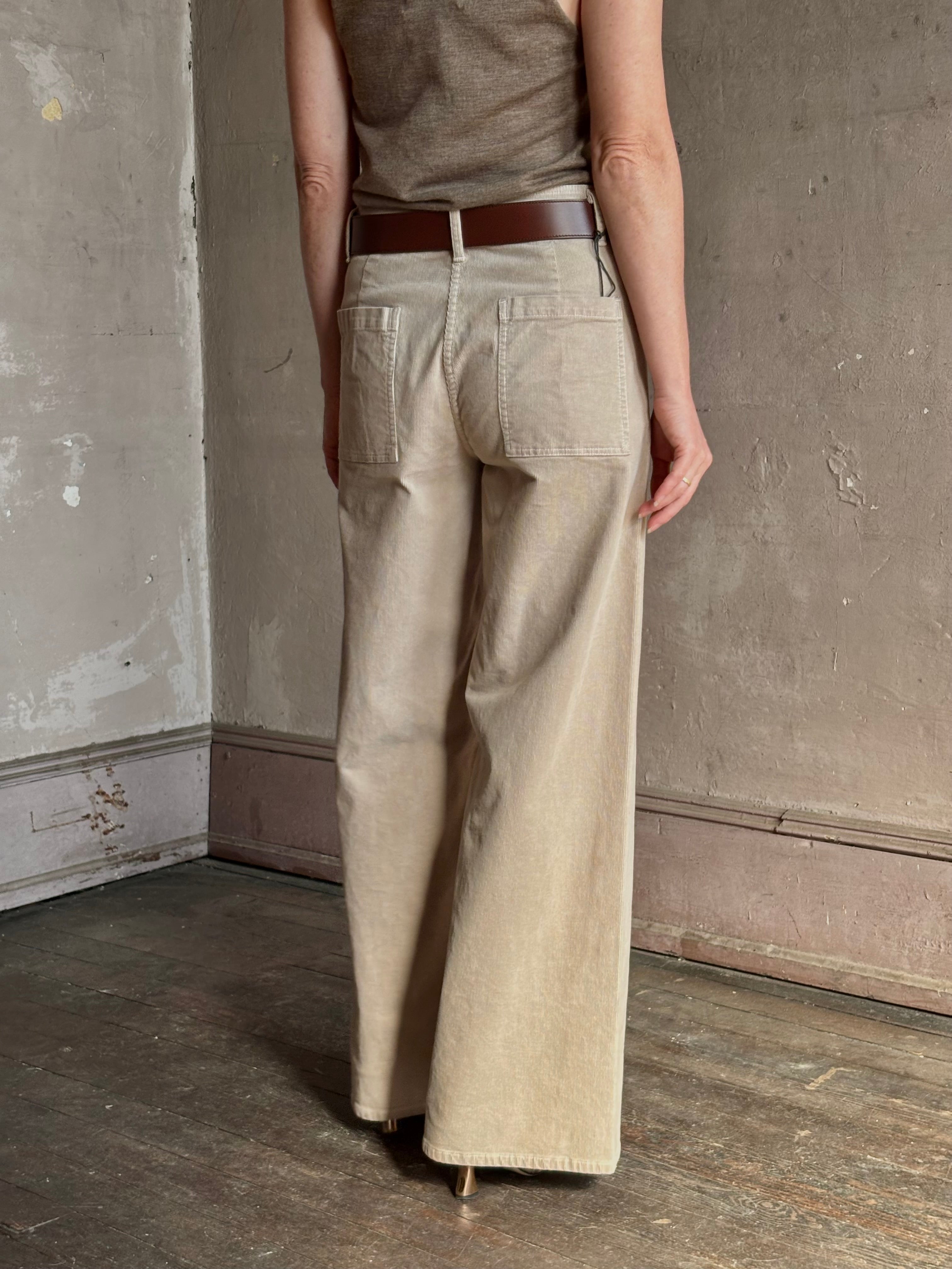 Mature woman wearing Nili Lotan flat front straight leg megan pant in beige corduroy mid rise machine washable cotton