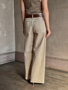 Mature woman wearing Nili Lotan flat front straight leg megan pant in beige corduroy mid rise machine washable cotton