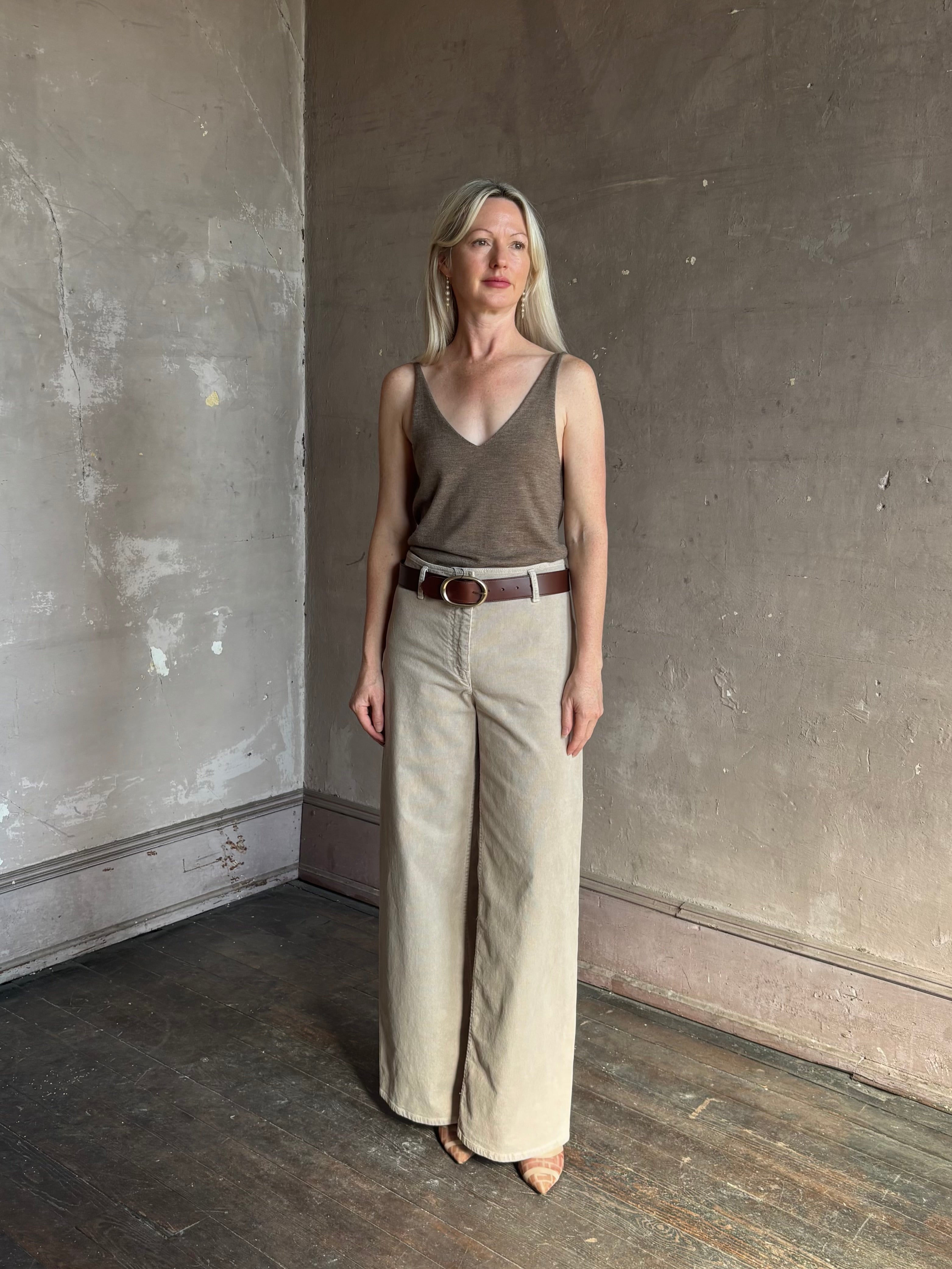 Mature woman wearing Nili Lotan flat front straight leg megan pant in beige corduroy mid rise machine washable cotton