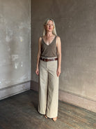 Mature woman wearing Nili Lotan flat front straight leg megan pant in beige corduroy mid rise machine washable cotton