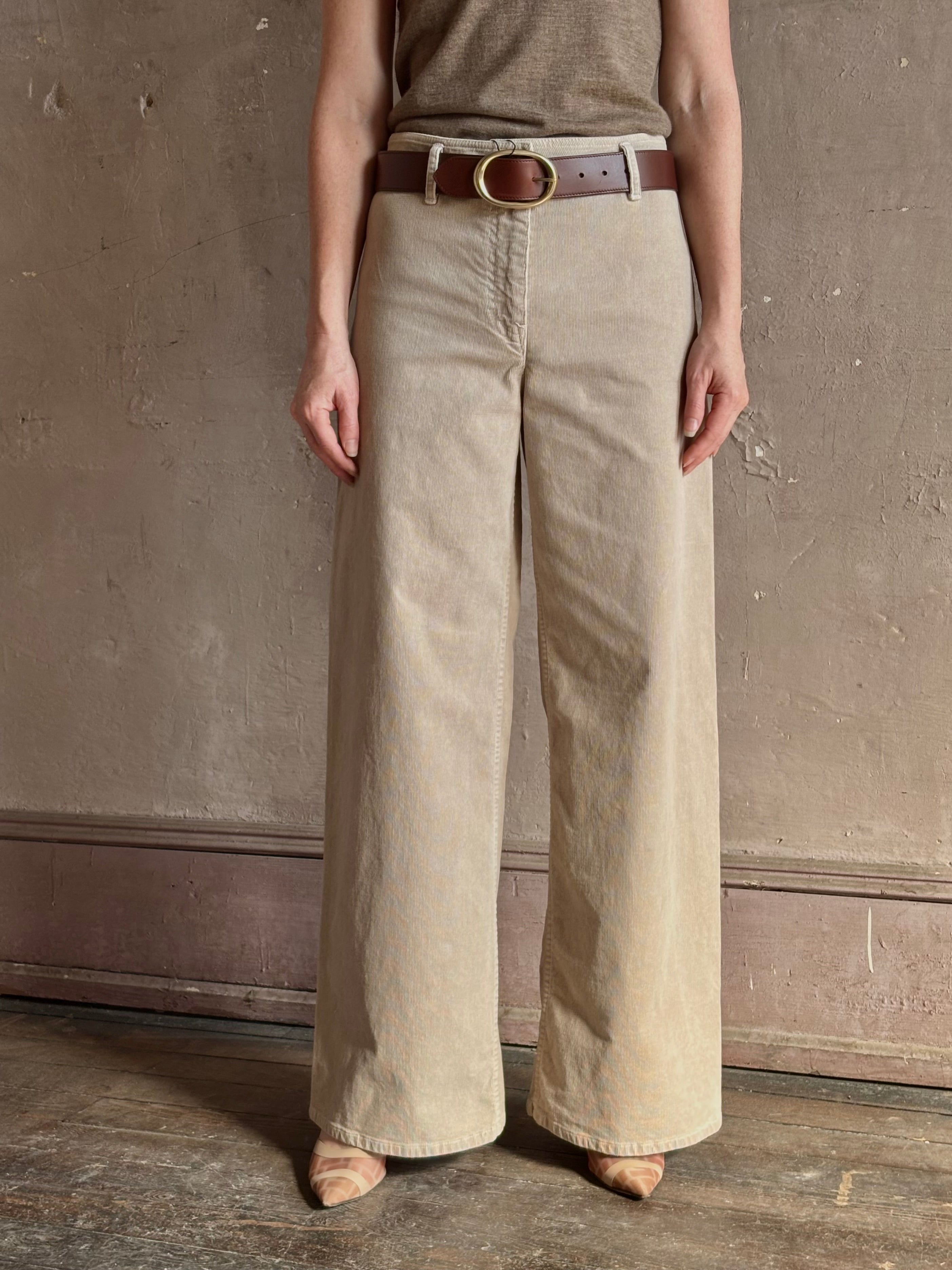 Mature woman wearing Nili Lotan flat front straight leg megan pant in beige corduroy mid rise machine washable cotton