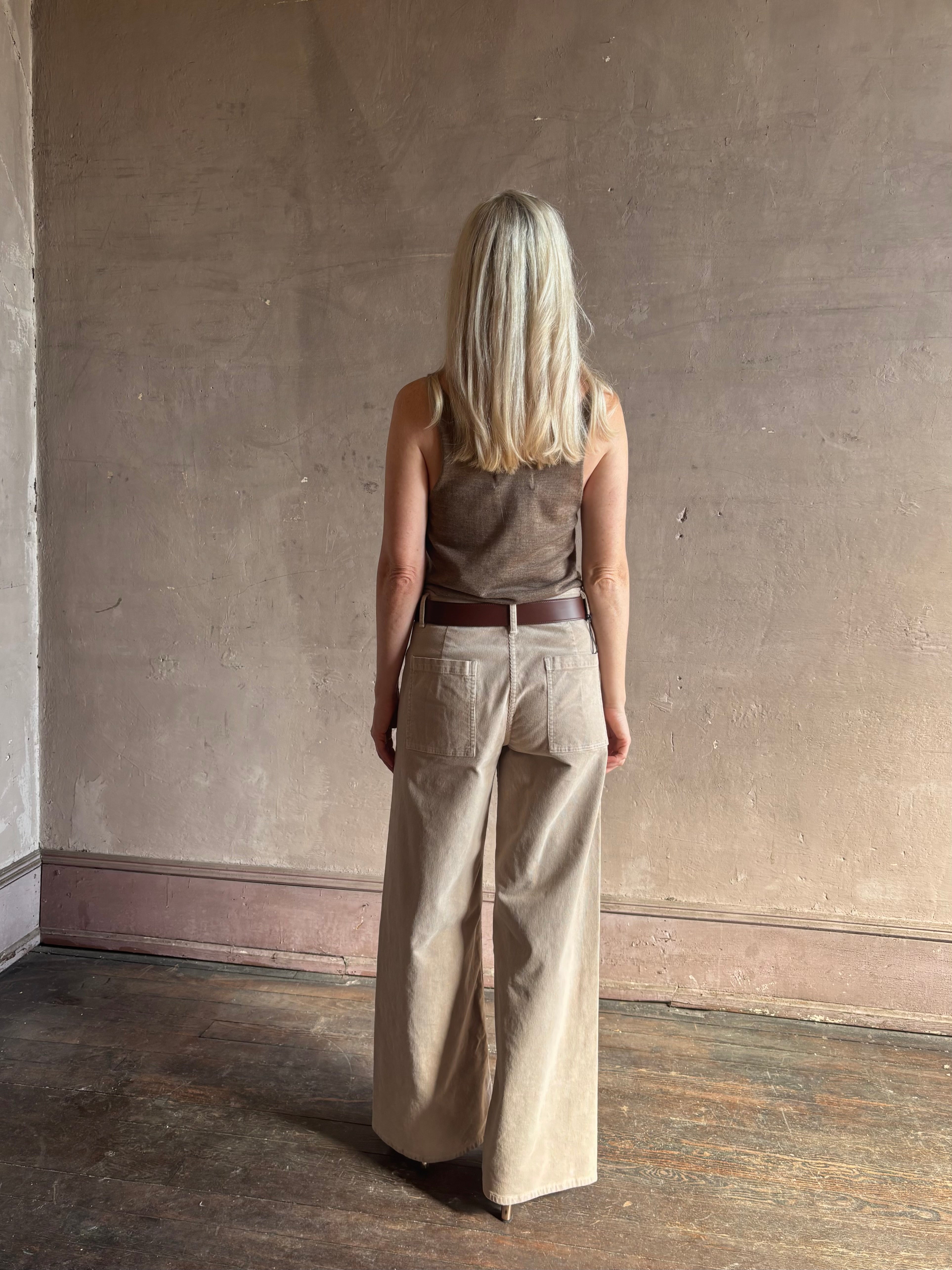 Mature woman wearing Nili Lotan flat front straight leg megan pant in beige corduroy mid rise machine washable cotton