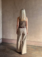 Mature woman wearing Nili Lotan flat front straight leg megan pant in beige corduroy mid rise machine washable cotton