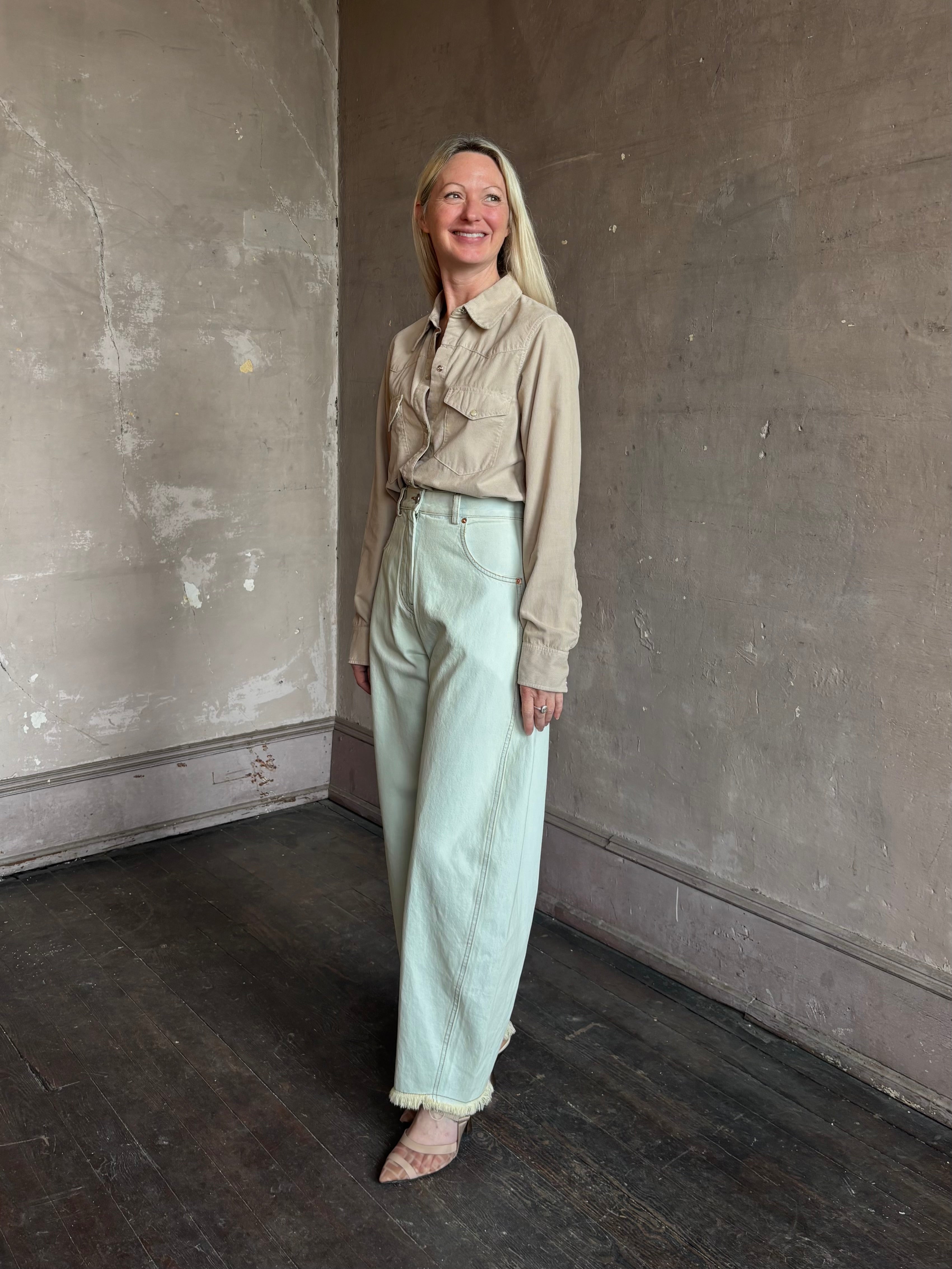Mature woman wearing Nili Lotan's Travis Corduroy Shirt in Travertine cotton corduroy Western-inspired snap buttons
