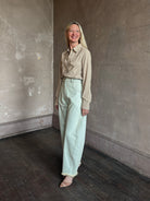 Mature woman wearing Nili Lotan's Travis Corduroy Shirt in Travertine cotton corduroy Western-inspired snap buttons