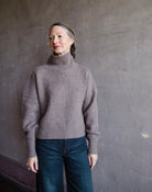 Front view of woman wearing Naadam luxe cashmere oversized turtleneck in brown