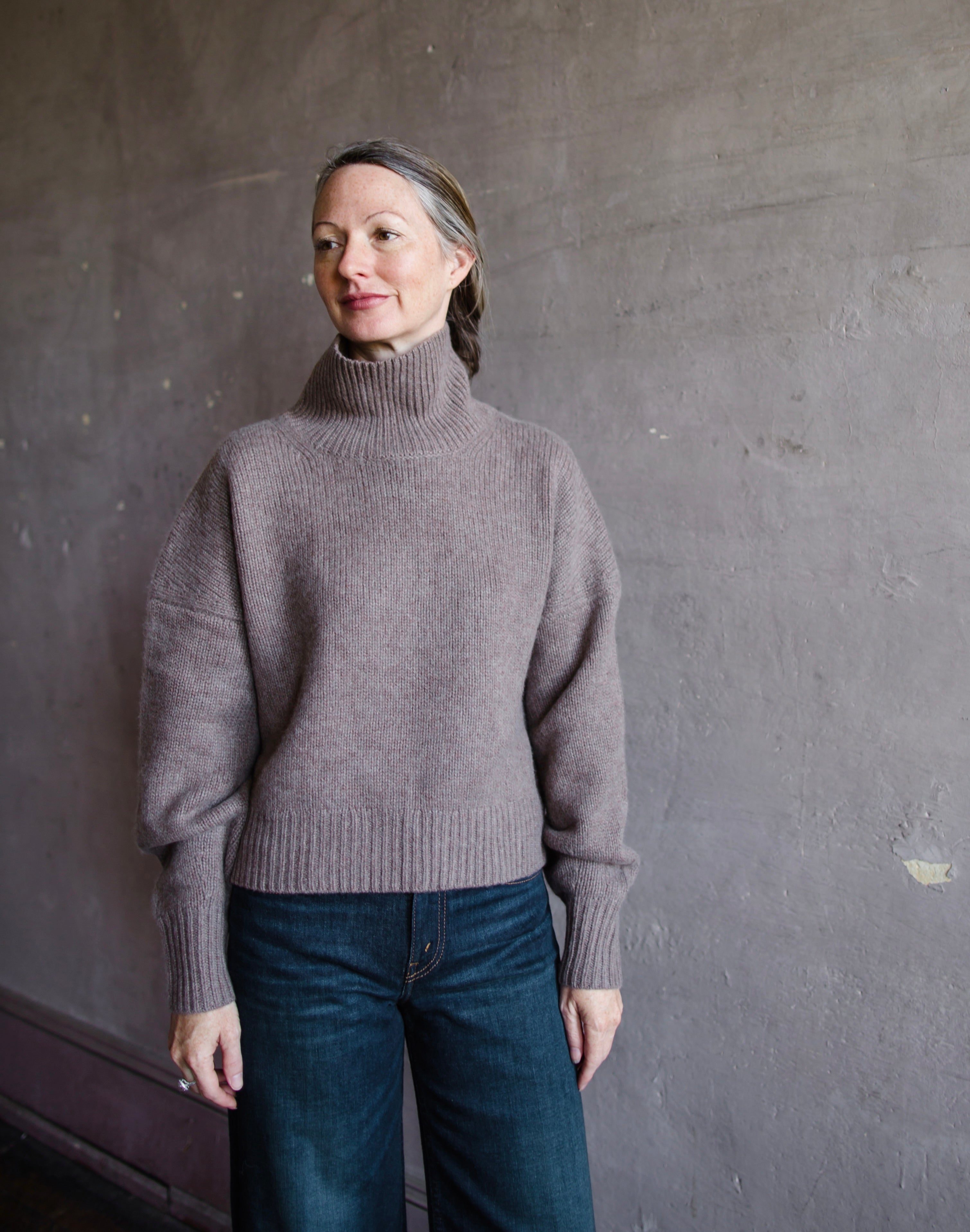 Front view of woman wearing Naadam luxe cashmere oversized turtleneck in brown