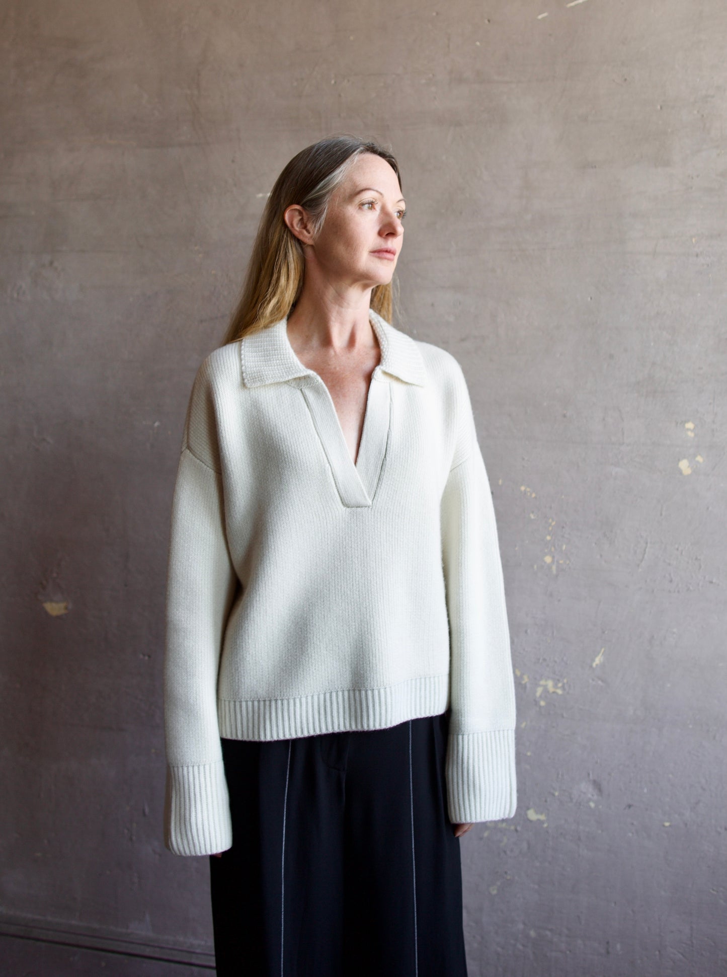 Image featuring a woman wearing this Ultra Luxe Cashmere Polo Sweater by Naadam in cream with a split neckline and collar in an oversized fit.