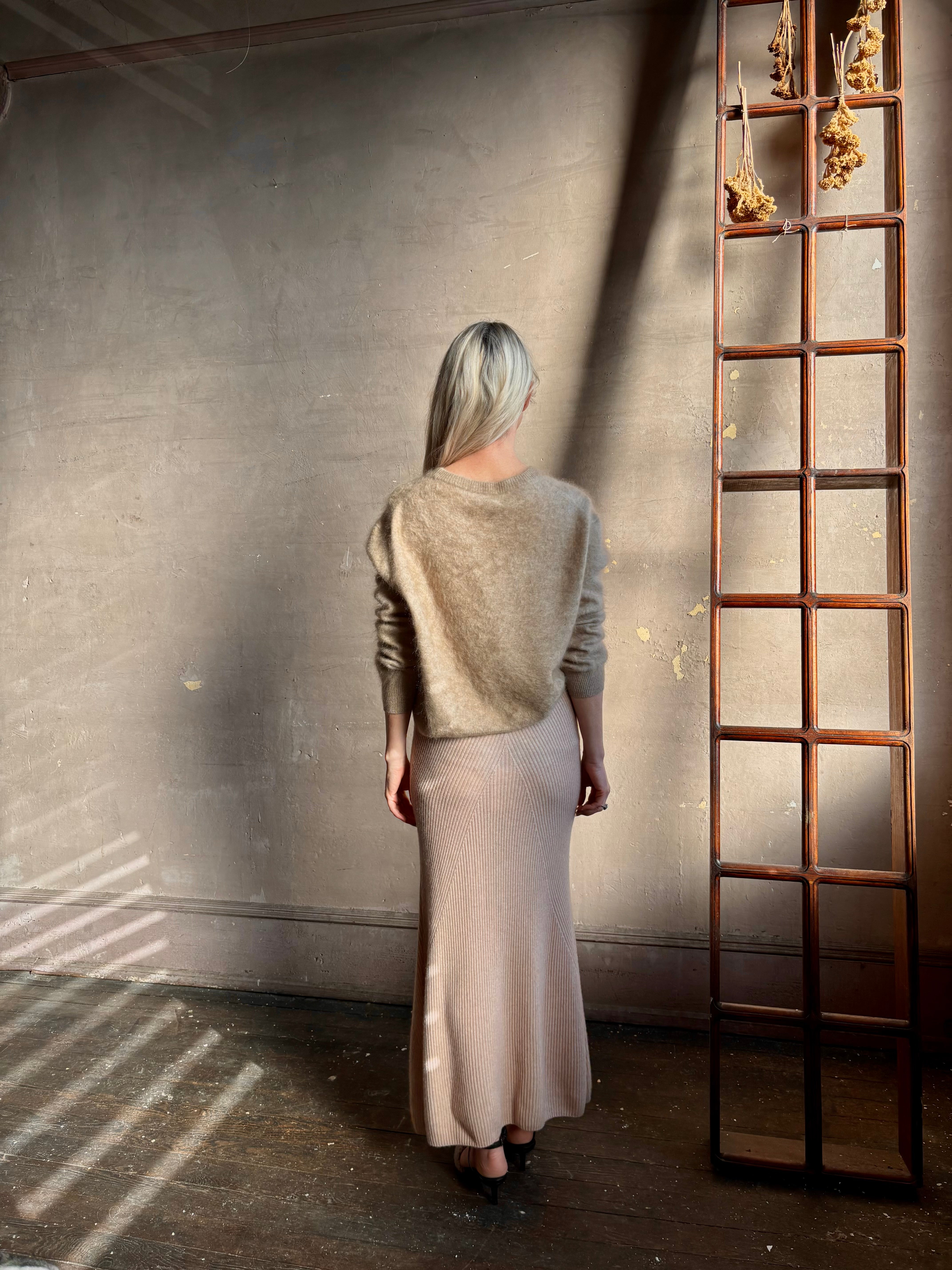 Mature woman wearing Naadam's Ribbed Maxi Skirt in Blush wool-cashmere blend  flexible waistband modern ribbed silhouette Soft elongating ethical luxury