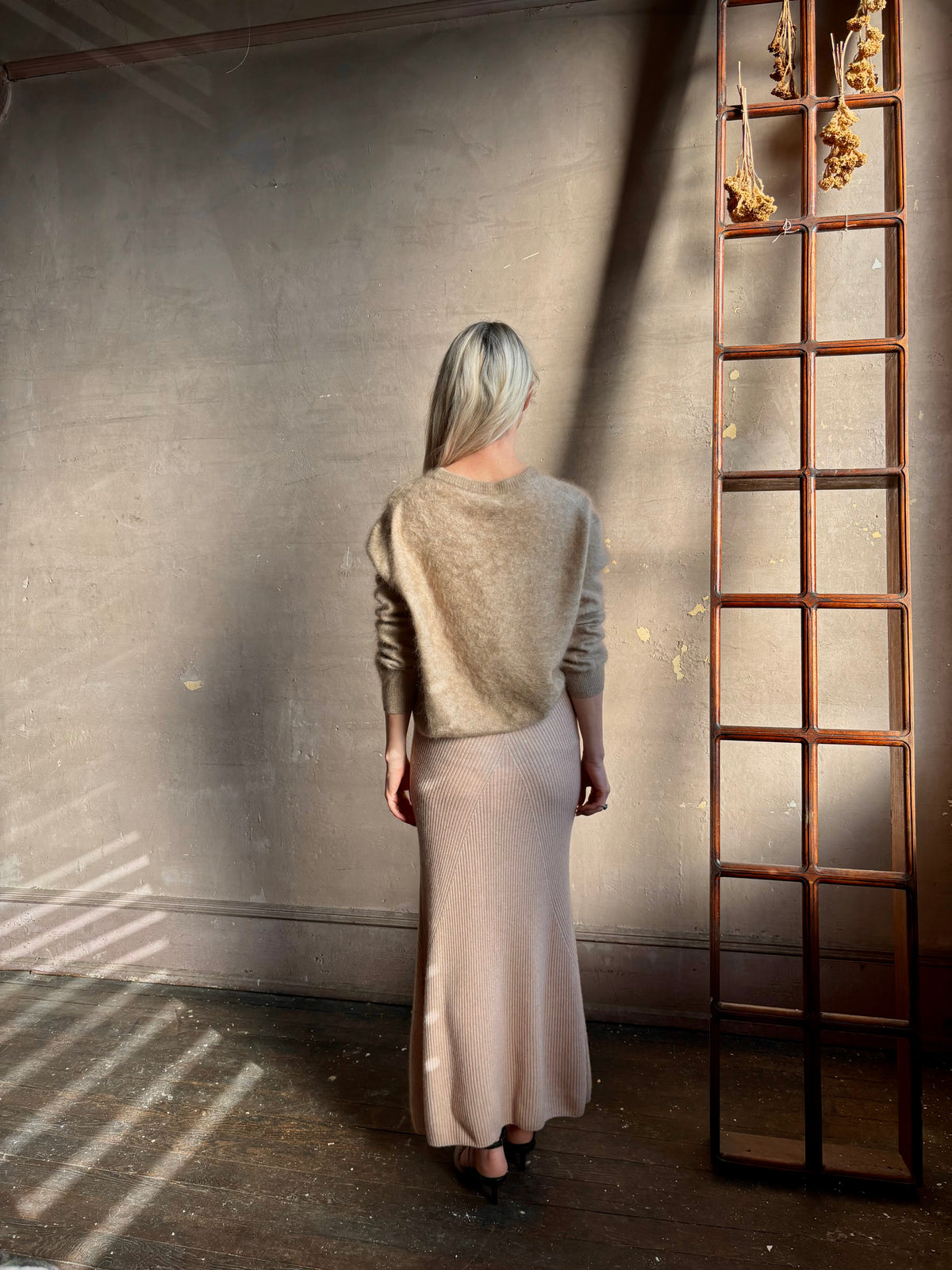 Mature woman wearing Naadam's Ribbed Maxi Skirt in Blush wool-cashmere blend  flexible waistband modern ribbed silhouette Soft elongating ethical luxury