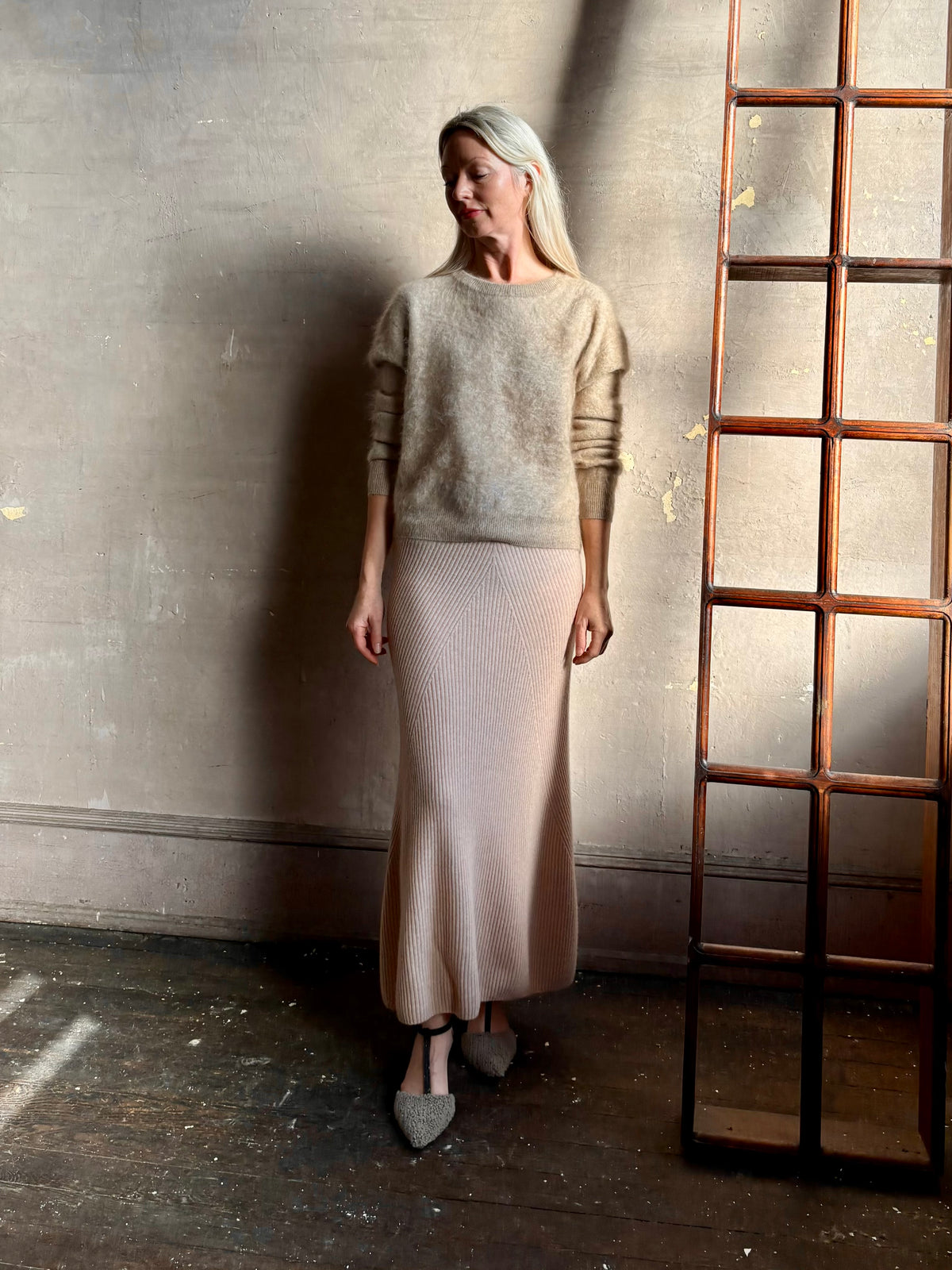 Mature woman wearing Naadam's Ribbed Maxi Skirt in Blush wool-cashmere blend  flexible waistband modern ribbed silhouette Soft elongating ethical luxury