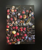 Ottolenghi's 'Flavor' cookbook with a glossy cover featuring a detailed photograph of roasted chestnuts and red fruits