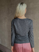 Woman wearing Proenza Schouler Blythe charcoal Top reversable long sleeves wool side ruching luxe draping