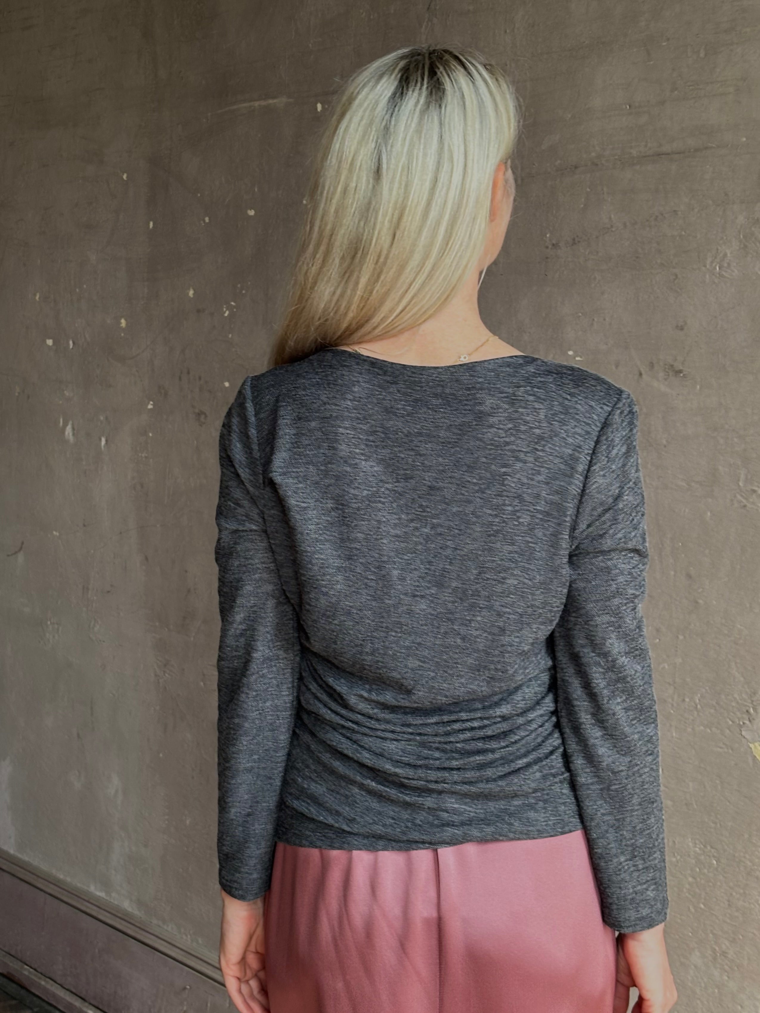 Woman wearing Proenza Schouler Blythe charcoal Top reversable long sleeves wool side ruching luxe draping