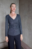 Model wearing Proenza Schouler Blythe Top in charcoal. Top can be reversed front or back offering two different looks. 