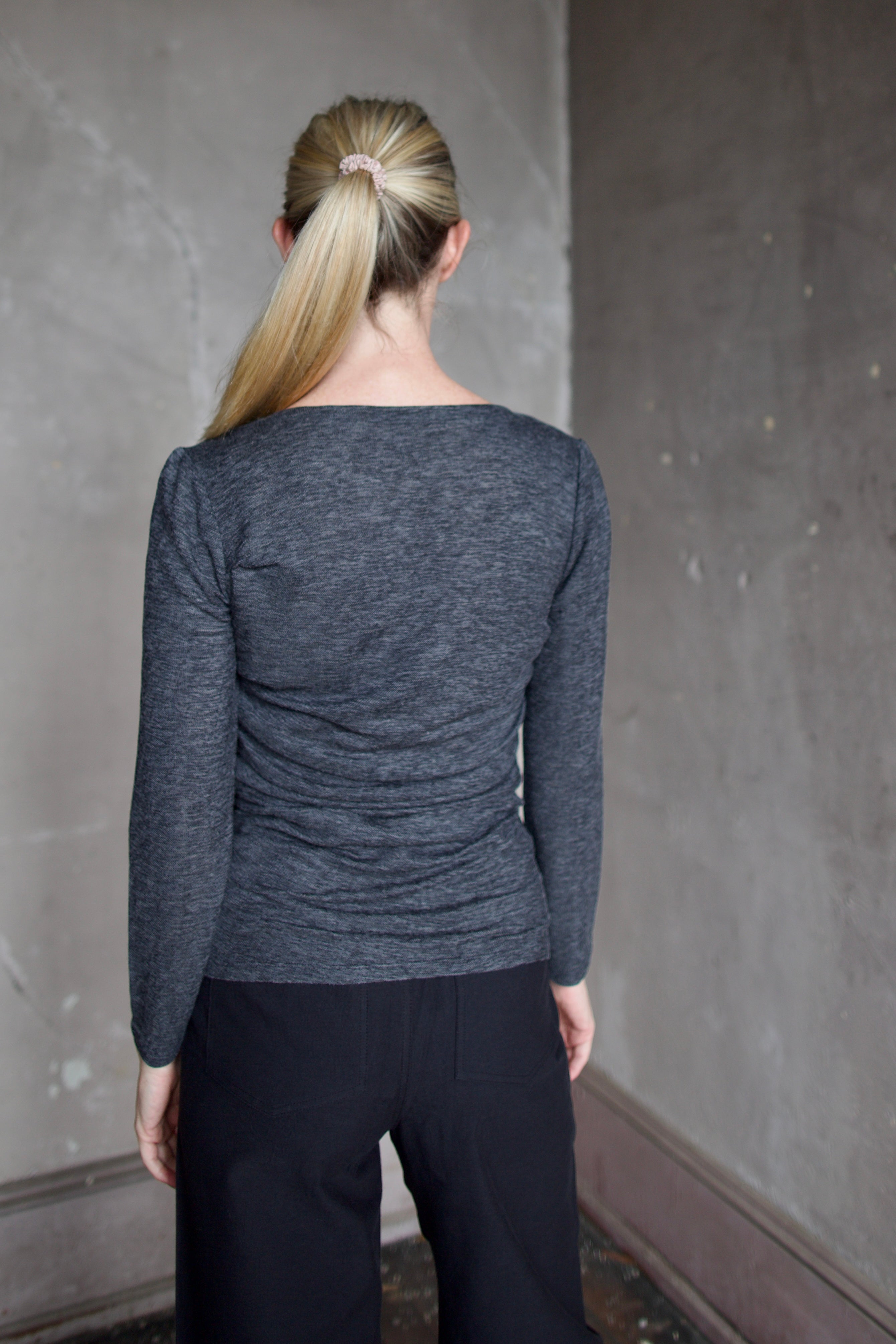 Model wearing Proenza Schouler Blythe Top in charcoal. Top can be reversed front or back offering two different looks. 