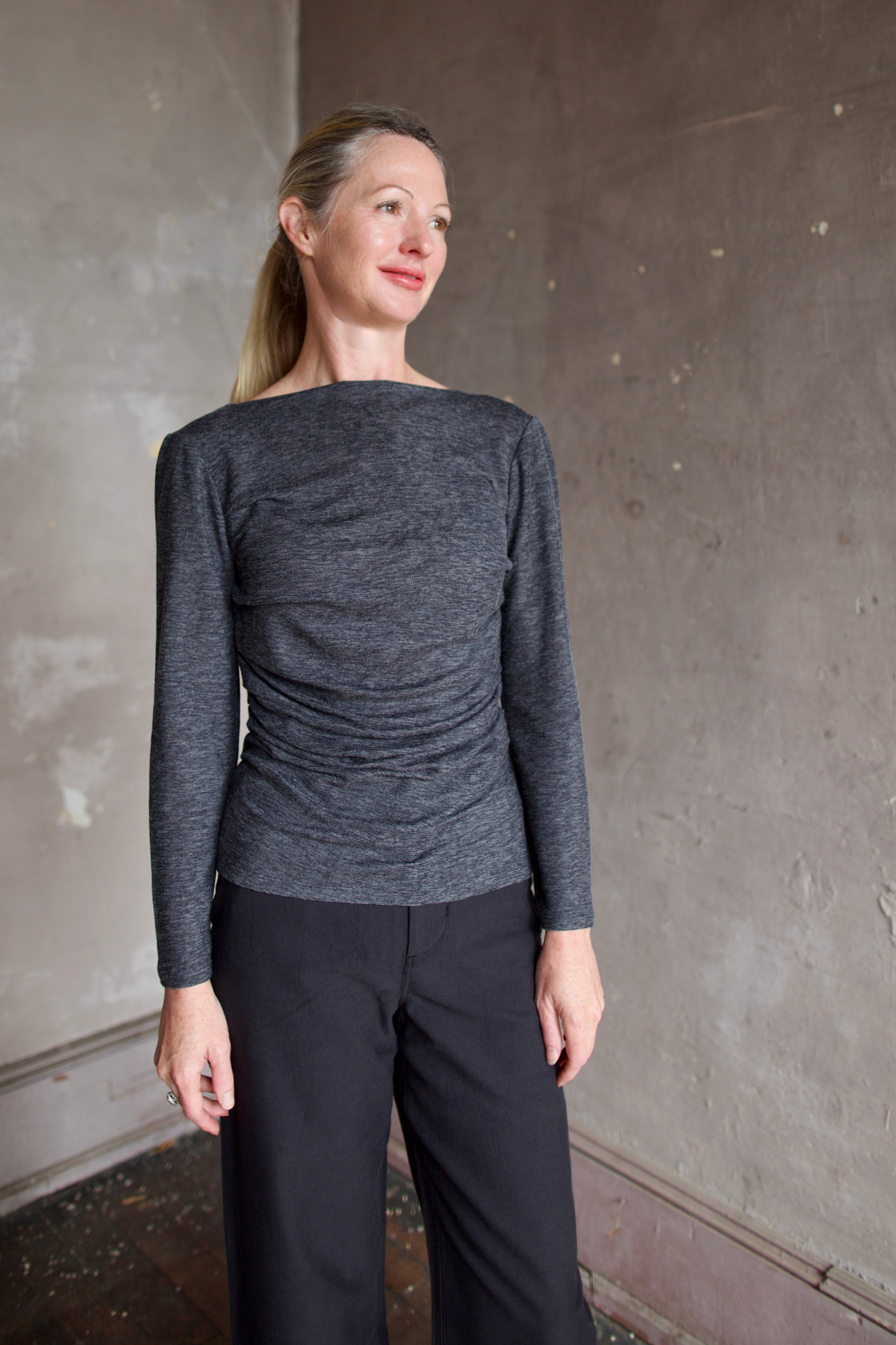 Model wearing Proenza Schouler Blythe Top in charcoal. Top can be reversed front or back offering two different looks. 