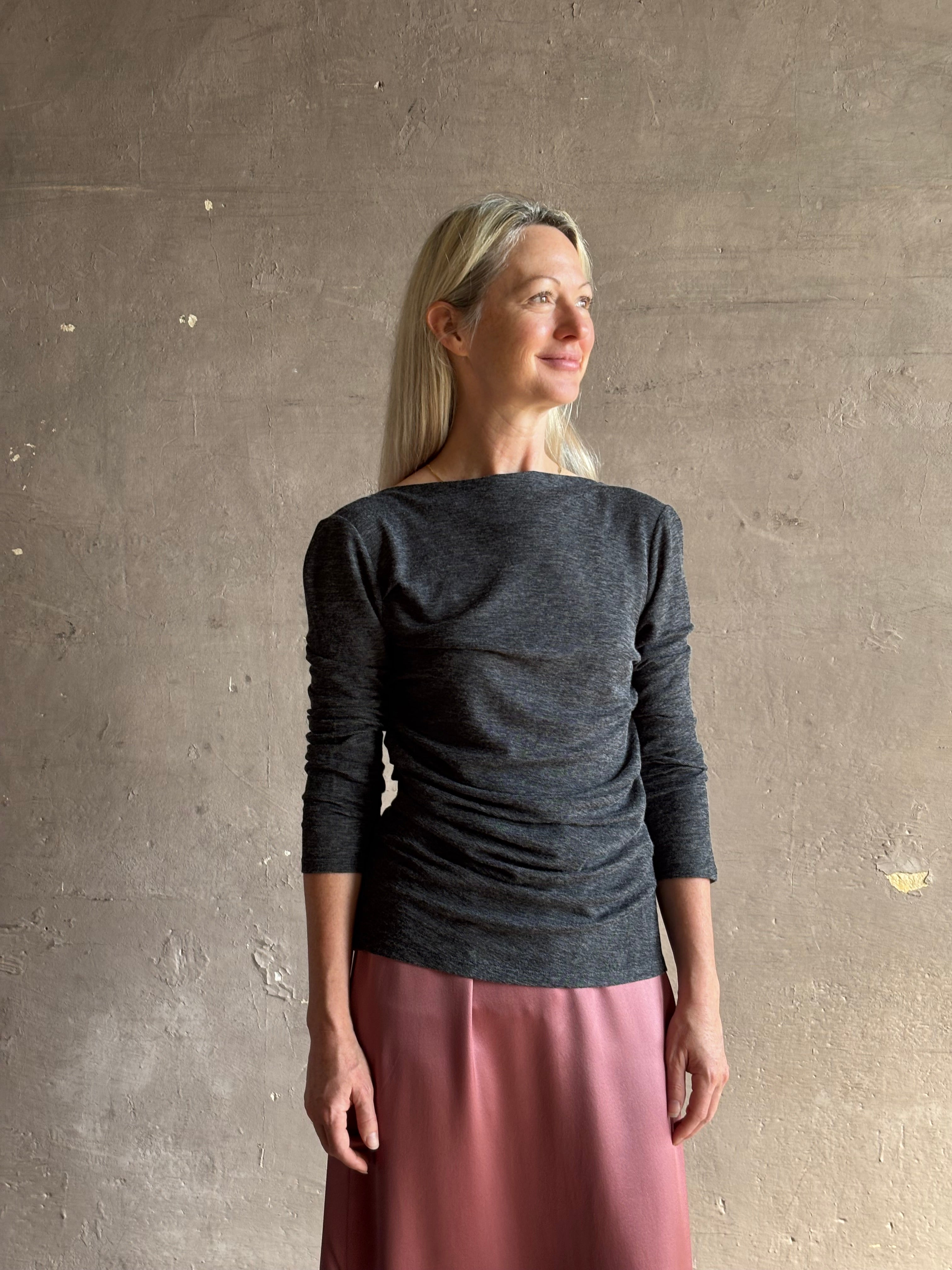 Woman wearing Proenza Schouler Blythe charcoal Top reversable long sleeves wool side ruching luxe draping