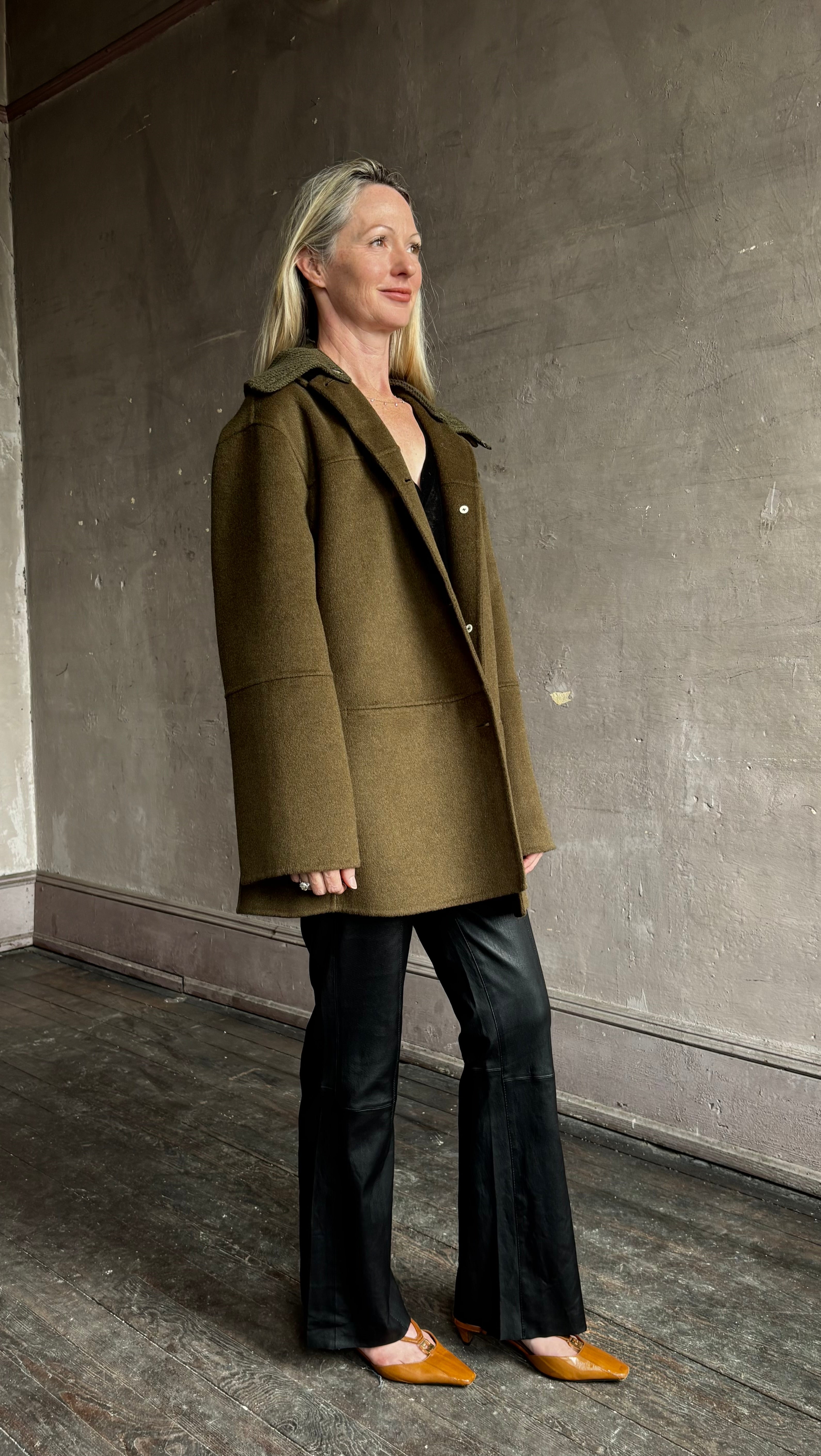 Image of woman wearing luxury brand Proenza Schoulder double faced green wool coat with detachable collar and classic back detailing