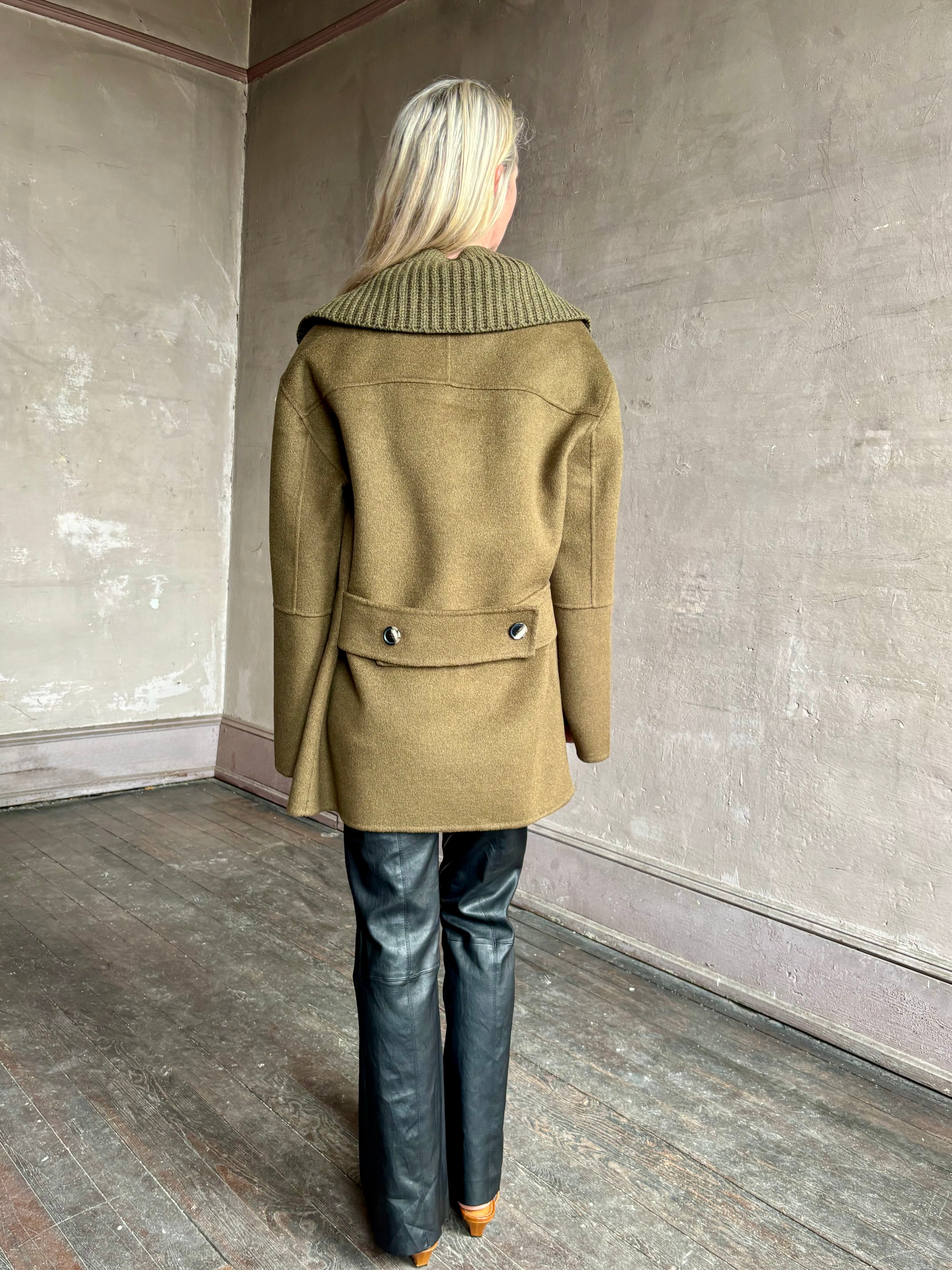 Image of woman wearing luxury brand Proenza Schoulder double faced wool coat with detachable collar and classic back detailing