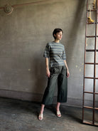 woman wearing Proenza Schoulder Dana sweater with short-sleeve knit top with blue, gray, and beige horizontal stripes 