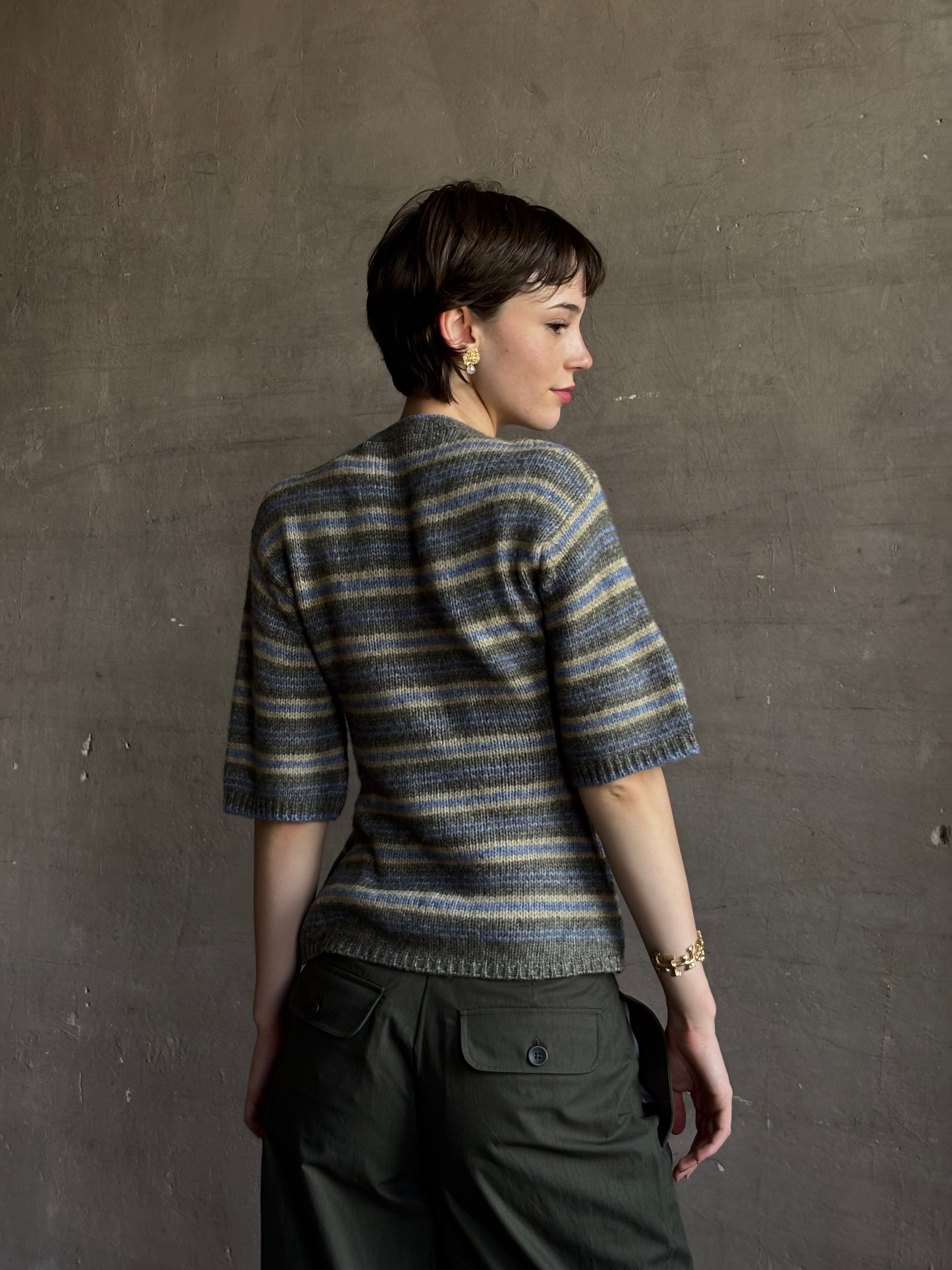 woman wearing Proenza Schoulder Dana sweater with short-sleeve knit top with blue, gray, and beige horizontal stripes 