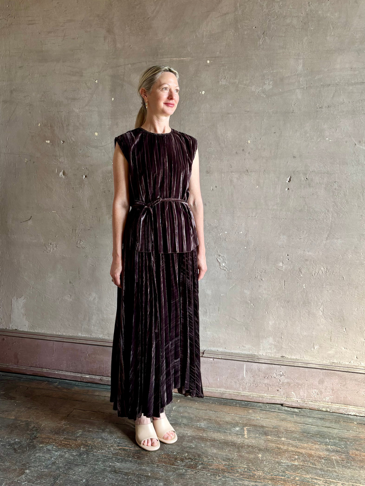 Mature woman wearing Proenza Schouler White Label Daphne crushed velvet Skirt A-line broomstick pleating occasion-ready 
