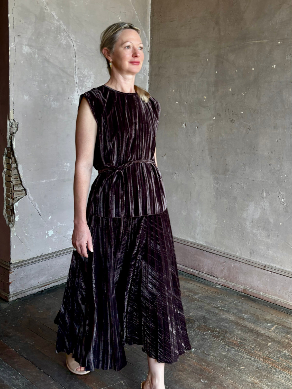 Mature woman wearing Proenza Schouler White Label Daphne crushed velvet Skirt A-line broomstick pleating occasion-ready 