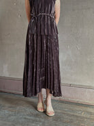 Mature woman wearing Proenza Schouler White Label Daphne crushed velvet Skirt A-line broomstick pleating occasion-ready 