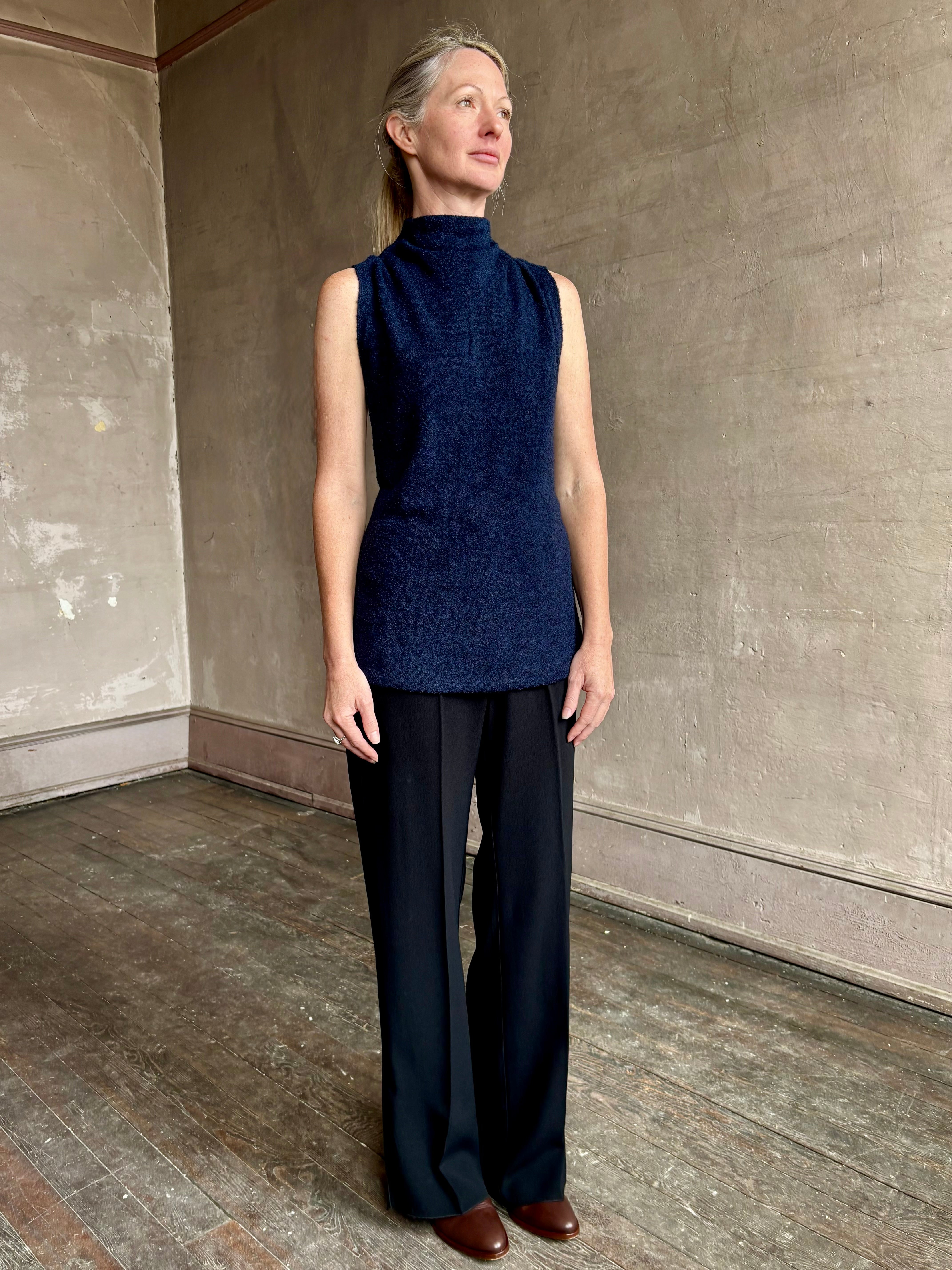 Image of mature woman wearing proenza schouler cynthia sleeveless top in a boucle texture and a mock neck