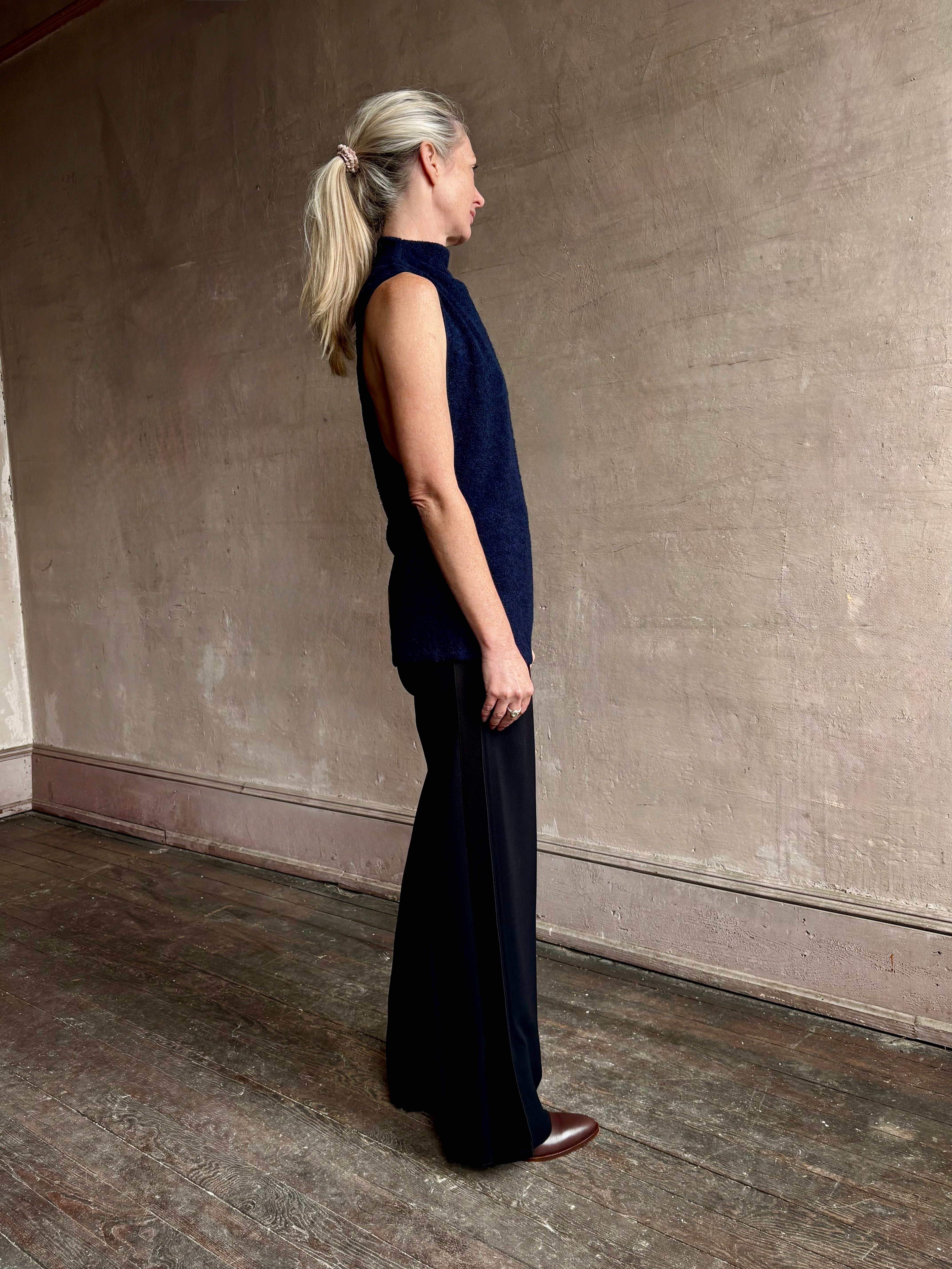 Image of mature woman wearing proenza schouler cynthia sleeveless top in a boucle texture and a mock neck