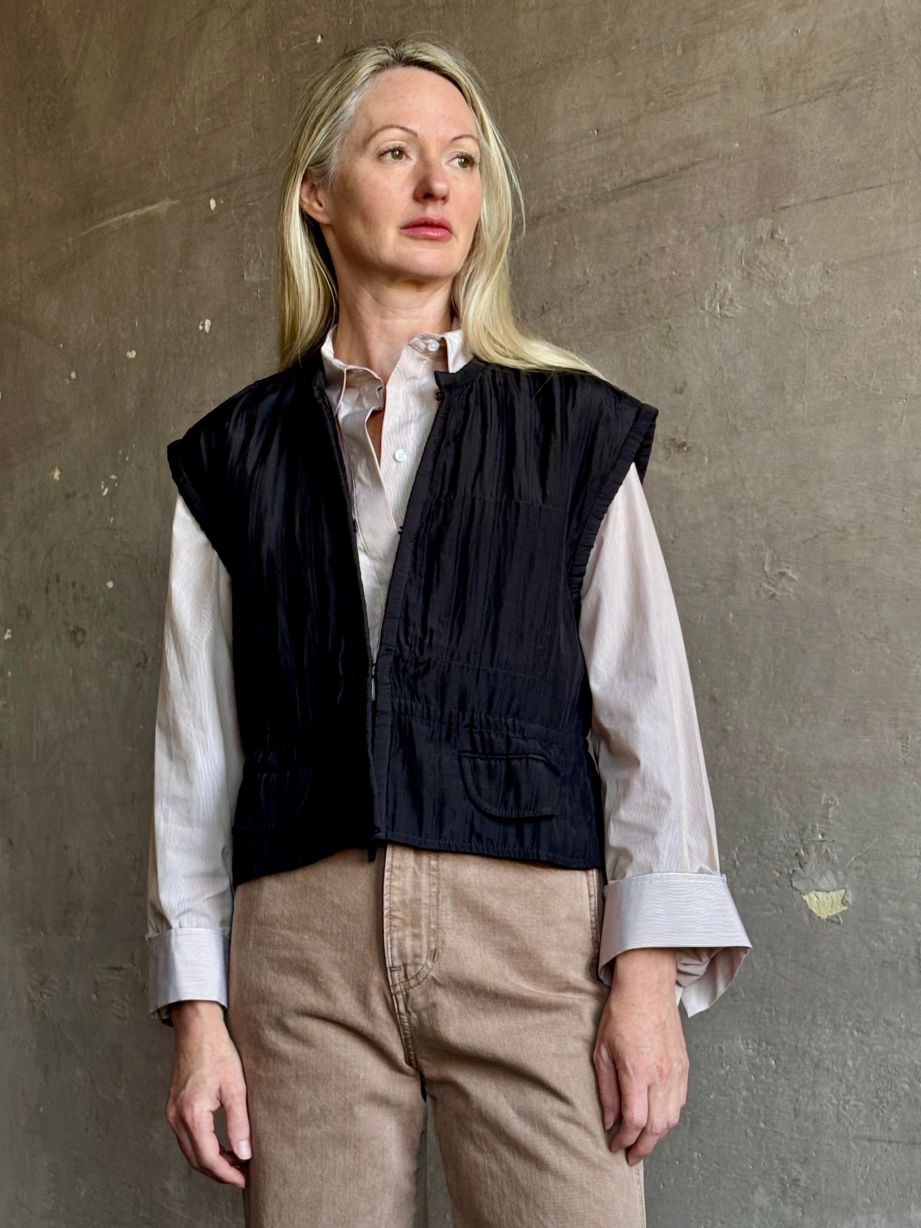Image of mature model wearing American designer Rachel Comey Clifford quilted silk vest in solid black showcasing refined versatility