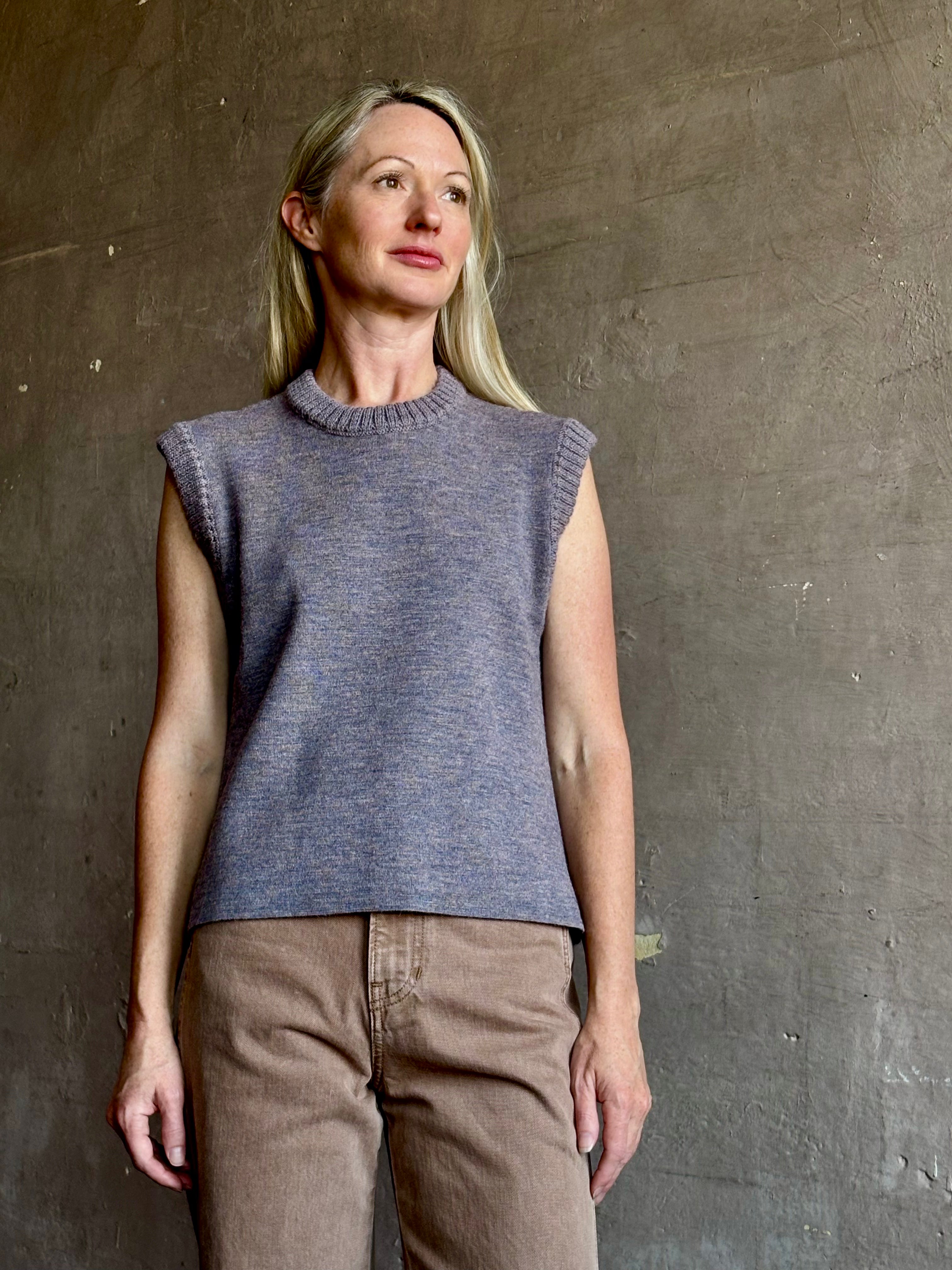 Mature woman wearing a quality sleeveless lilac knit top fabricated from baby alpaca by designer Rachel Comey