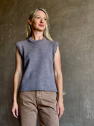 Mature woman wearing a quality sleeveless lilac knit top fabricated from baby alpaca by designer Rachel Comey