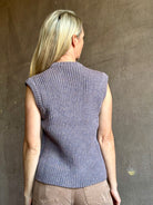 Mature model wearing a quality lilac knit top fabricated from baby alpaca by designer Rachel Comey