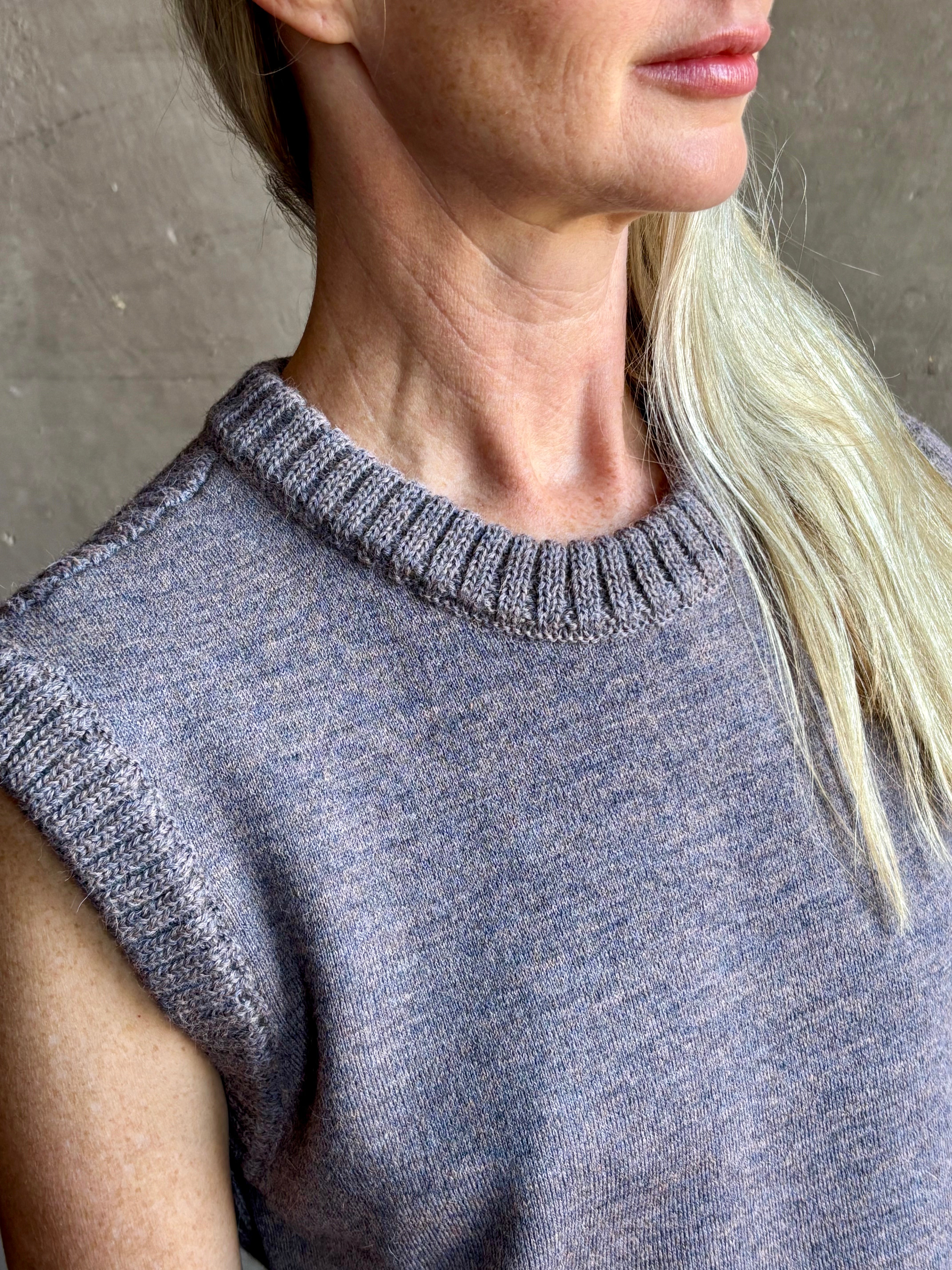 Mature model wearing a quality lilac knit top fabricated from baby alpaca by designer Rachel Comey