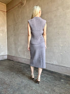 Mature model wearing a quality lilac knit skirt and top set fabricated from baby alpaca by designer Rachel Comey
