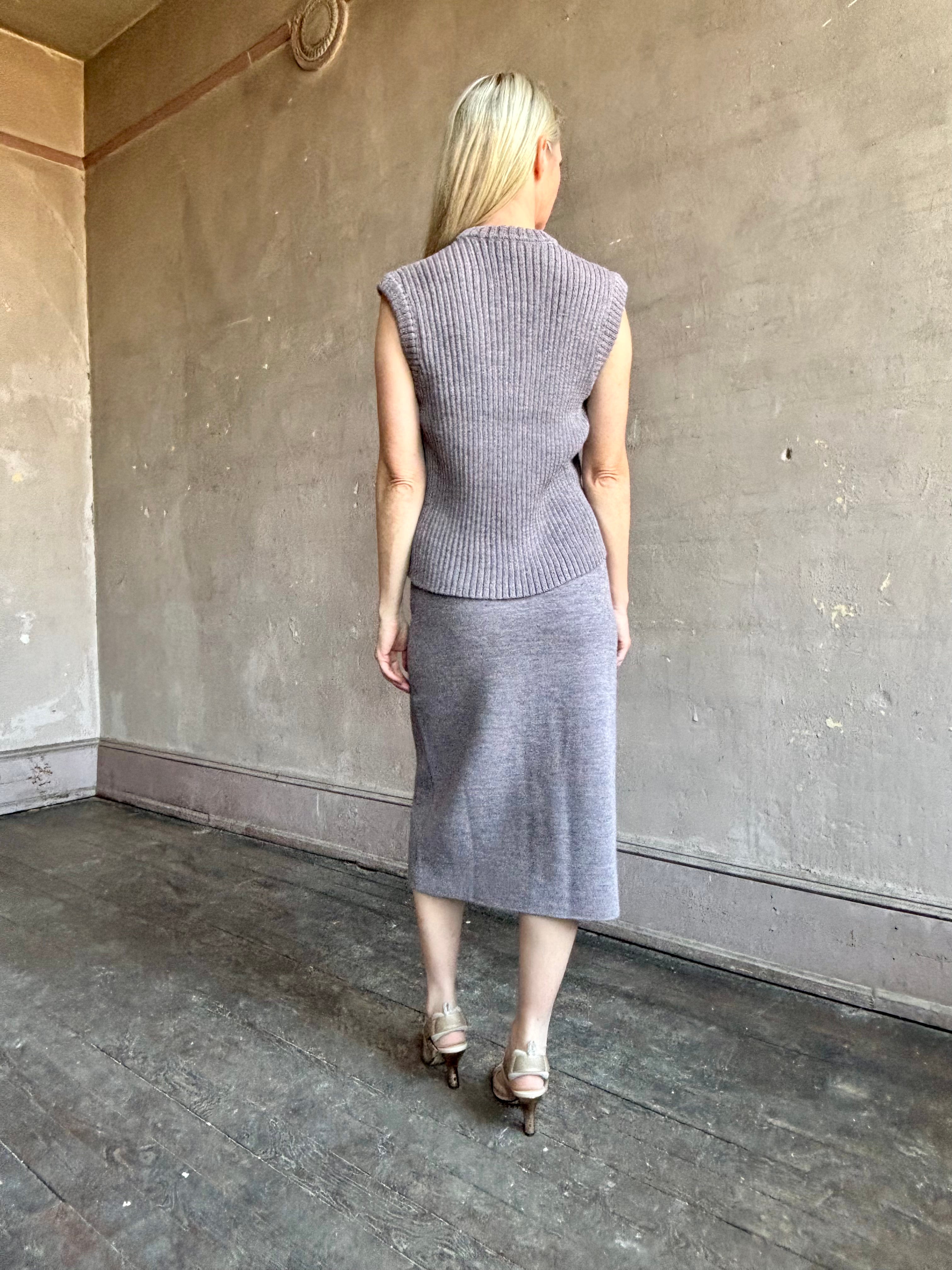 Mature model wearing a quality lilac knit skirt and top set fabricated from baby alpaca by designer Rachel Comey
