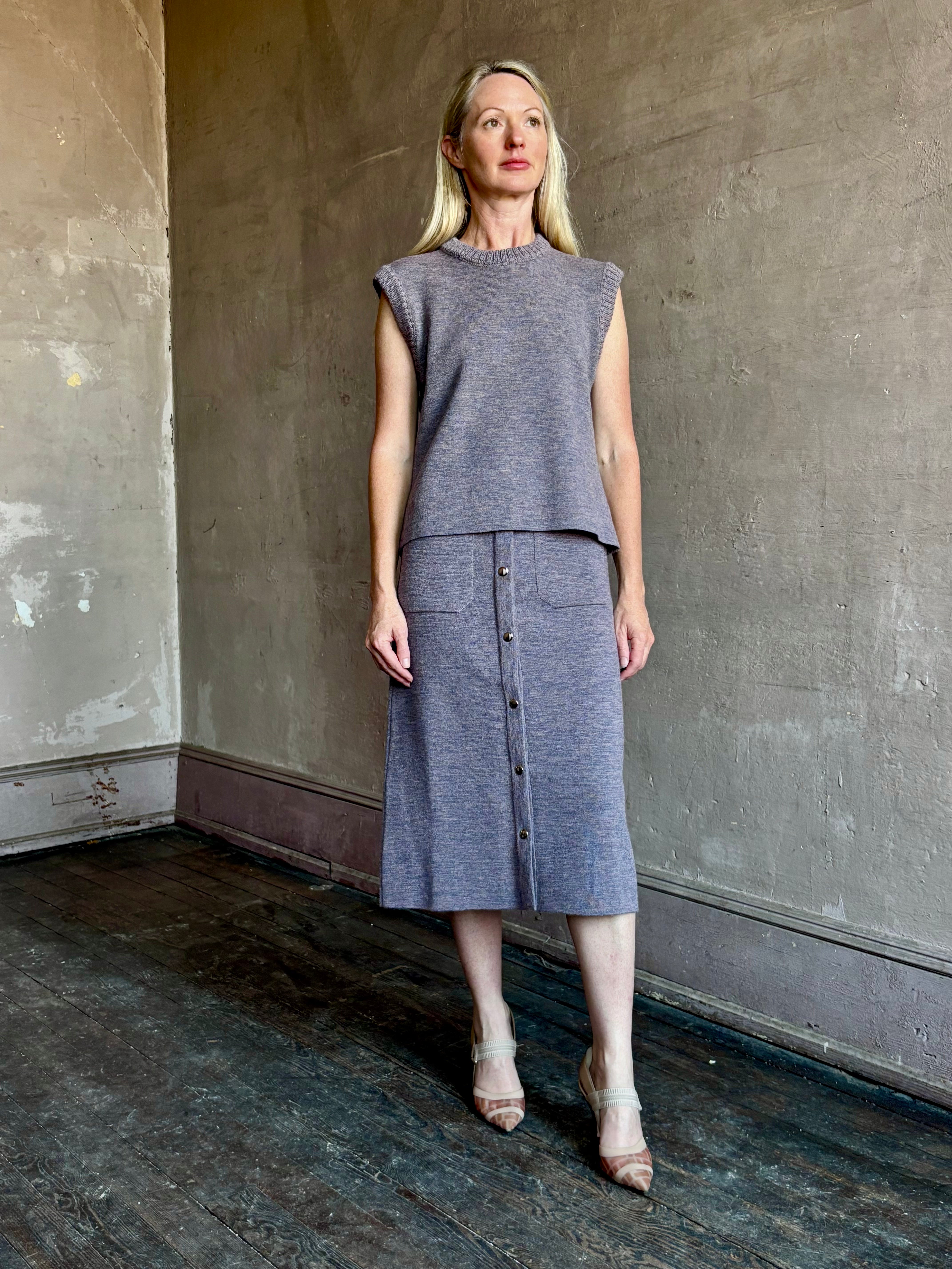 Mature model wearing a quality lilac knit skirt and matching top fabricated from baby alpaca by designer Rachel Comey