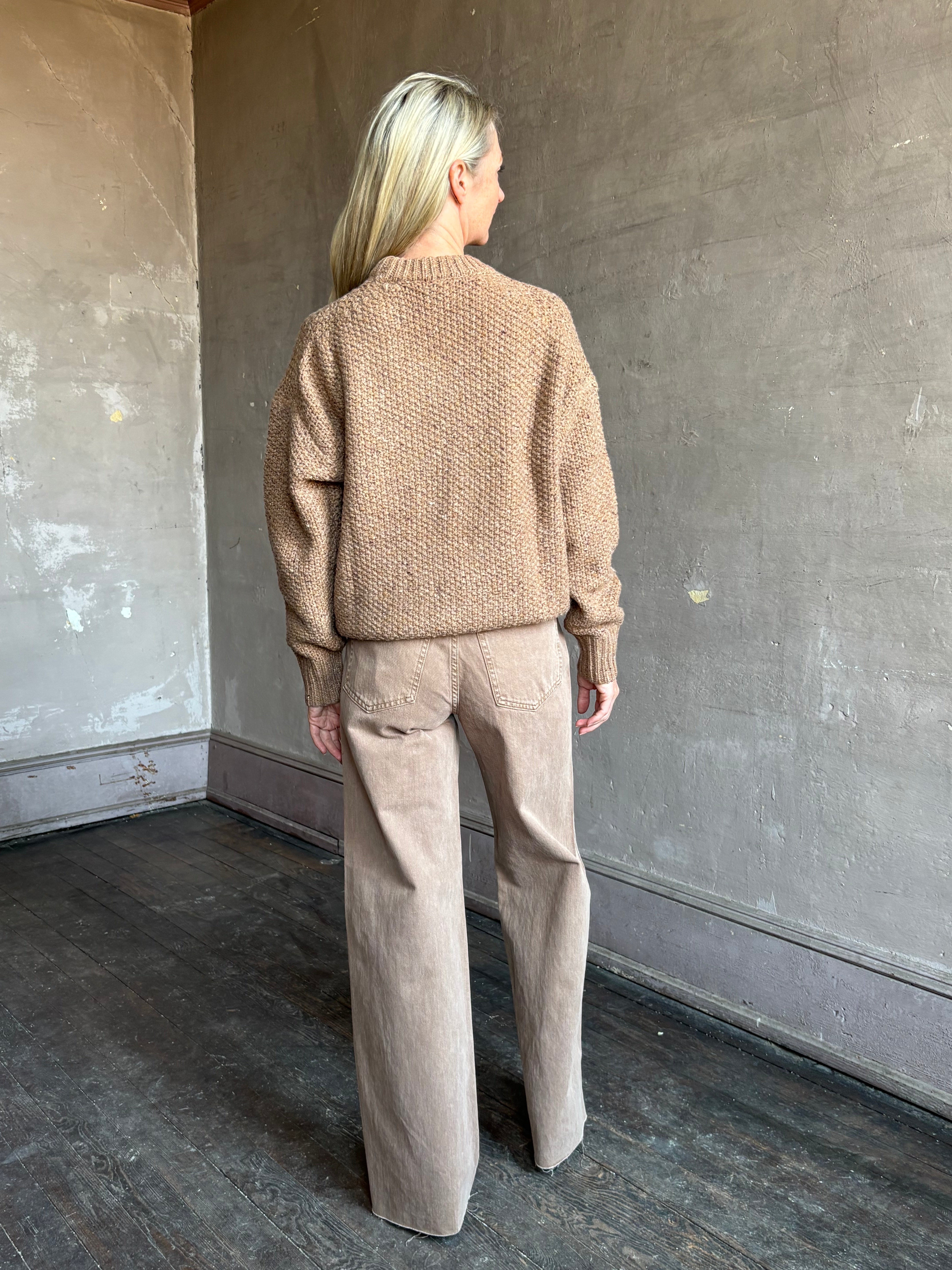 Image of mature woman wearing American designer Rachel Comey prescot sweater in a warm neutral colorway made with fine merino wool