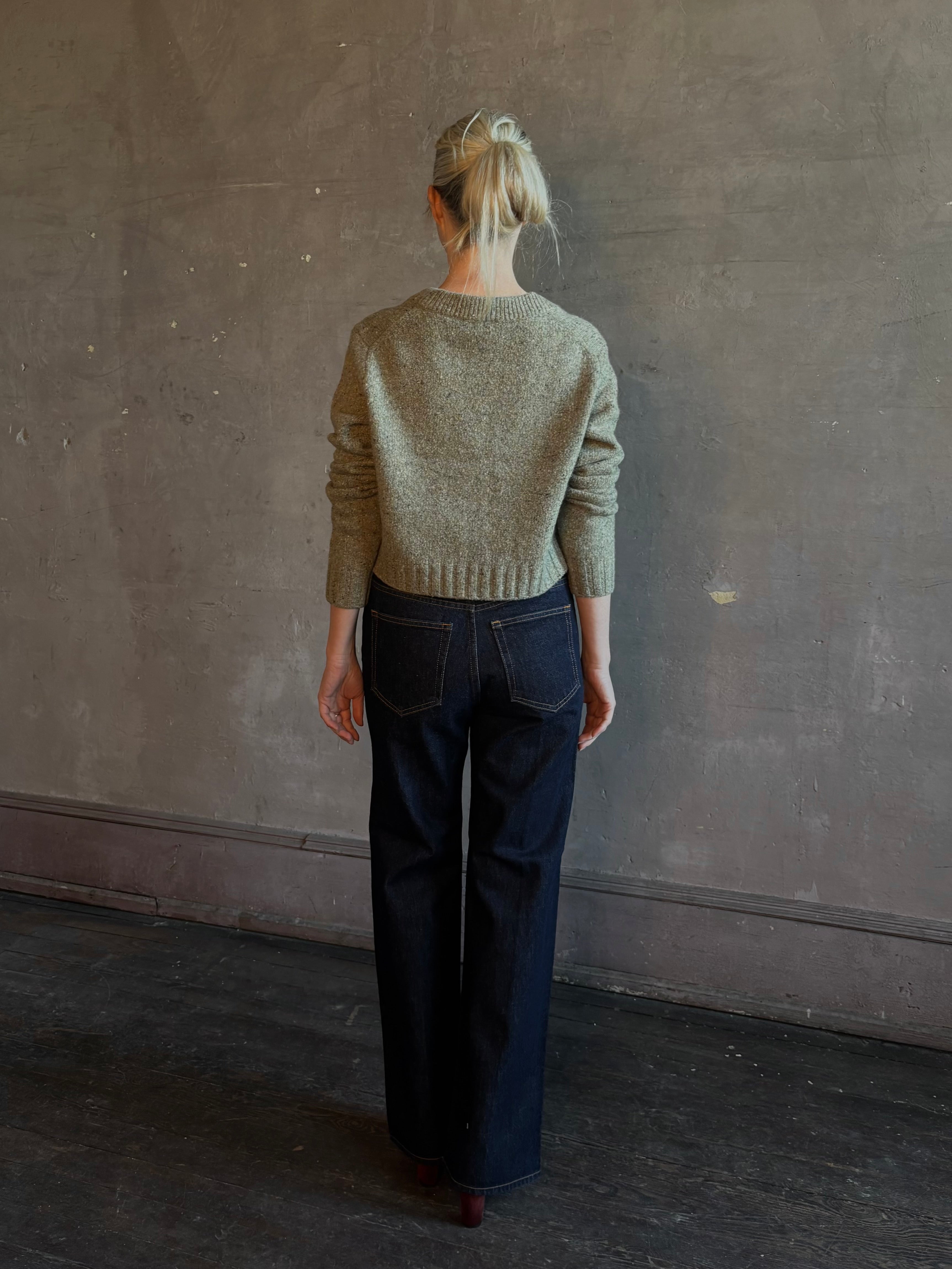 Mature woman wearing Rachel Comey Uridge Cardigan in Stone Green RWS-certified merino blend with U-neckline everyday layering