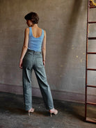 Woman wearing designer Rachel Comey Dardo green stretch cotton Pant  intricate back detail similar to Alaia